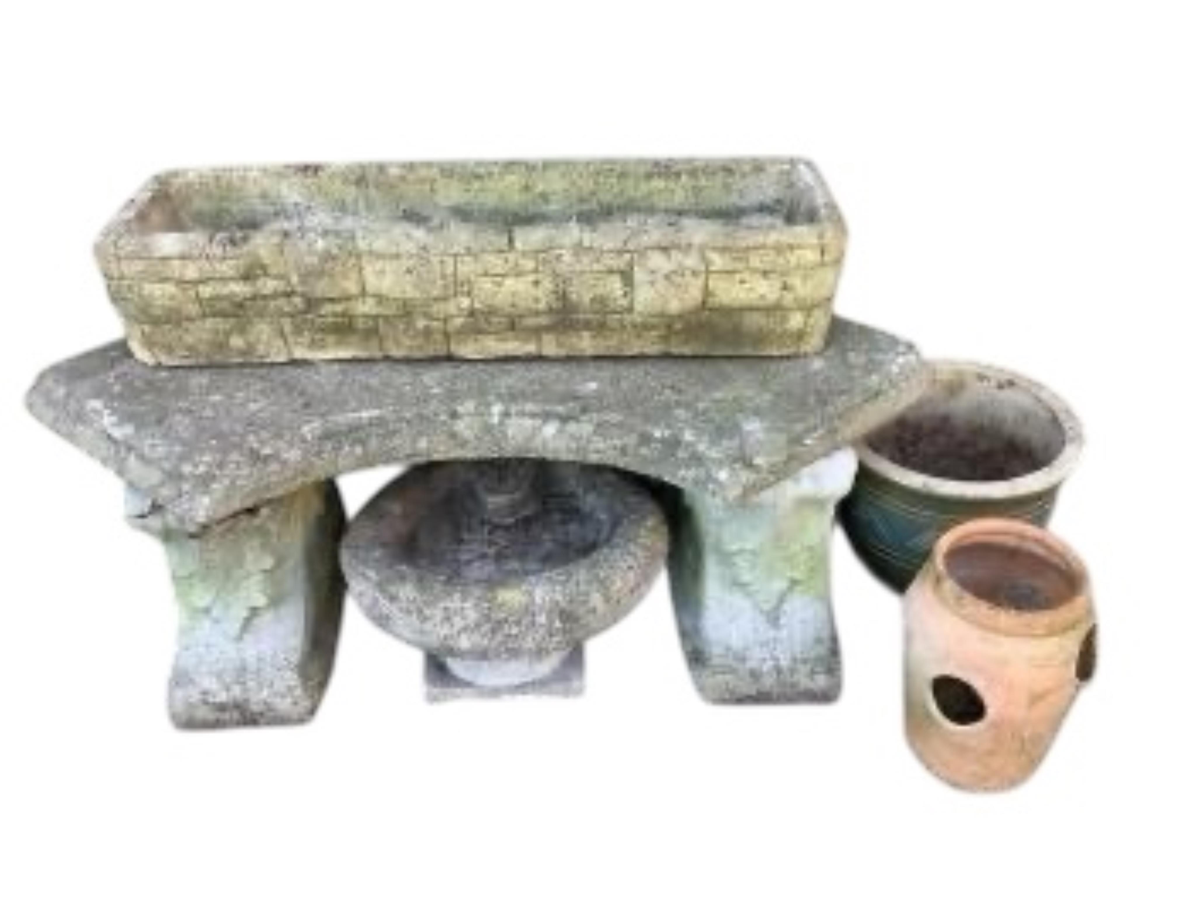 A curved reconstituted stone garden bench, length 102cm, together with three planters and a bird bath